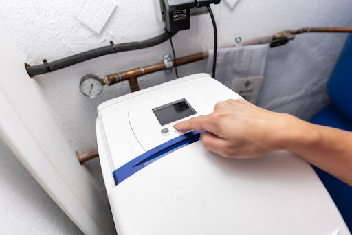 Programming pressurized water softeners in a home shed.